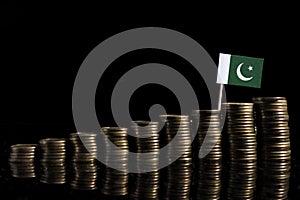 Pakistan flag with lot of coins on black