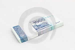 Pakistan one thousand rupees denomination note bundle on white isolated background