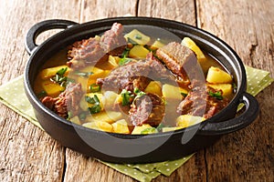 Pakistani Aloo Gosht or Meat and Potato Curry closeup in the pan. Horizontal photo