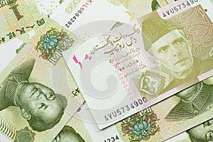 A Pakistani rupee bank note with Chinese one yuan bills