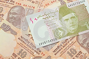 A Pakistani rupee bank note with Indian ten rupee bank notes