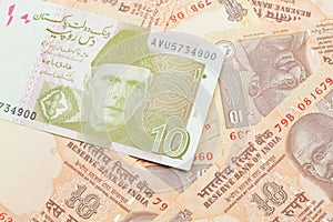 A Pakistani rupee bank note with Indian ten rupee bank notes