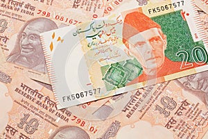 A Pakistani rupee bank note with Indian twenty rupee bank notes