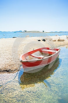 Pakostane, Croatia - A red rowing boat at the beach of Pakostane