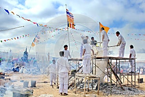 The ceremony of pouring gold Buddha are use is molten metal is poured into a sand mold aluminum to casting Buddha statue.