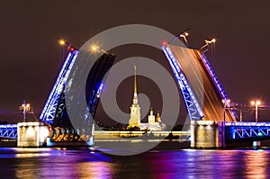 The Palace Bridge and the Peter and Paul Fortress at night on the Neva River in Saint- Petersburg.