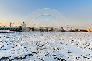 Palace Bridge and Vasilyevsky island Spit Strelka with Rostral columns in winter. Saint Petersburg, Russia