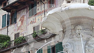 The palace frescoed behind the Fountain of Madonna Verona in Piazza delle Erbe in Verona