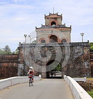 The Palace gate to the Hue Citadel with cyclist