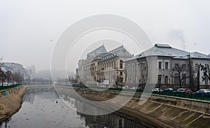 Palace of Justice building Palatul Justitiei early in the morning. View over Dambovita river in Bucharest, Romania, 2020