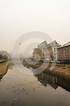 Palace of Justice building Palatul Justitiei early in the morning. View over Dambovita river in Bucharest, Romania, 2020