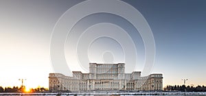 Palace of the Parliament building in Bucharest during an amazing winter sunset landscape landmark of Romania