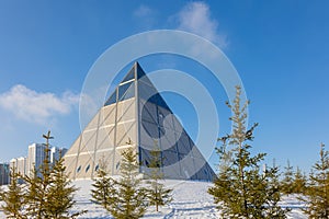 Palace of Peace and Accord. Modern architectural urbanistic city Astana. Futuristic building pyramids on sunny winter