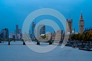 Palace of Westminster and Big Ben with the skyline of London city at sunset