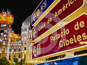 Palacio de Cibeles in Madrid Spain at night direction sign