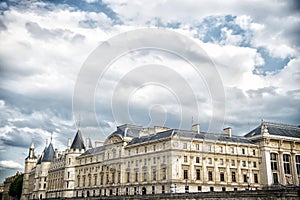 Palais de la Cite in Paris, France. Palace building with towers on cloudy sky. Monument of gothic architecture and design. Vacatio