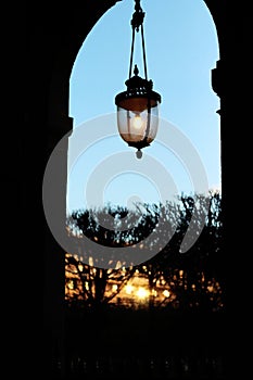 Palais royal gardens arcade lamppost light at sunset in Paris