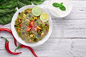 Palak Paneer Biryani and Raita at white background with decor. Palak Paneer Biryani is vegetarian indian cuisine dish