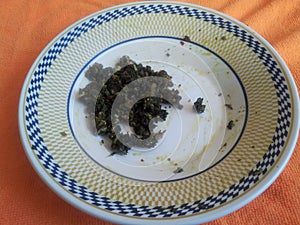 Palak Saag served in a ceramic plate on orange background