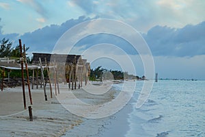 Palapas on a sandy beach of Gulf of Mexico