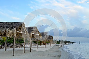 Palapas on a sandy beach of Gulf of Mexico