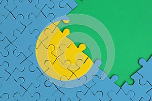 Palau flag is depicted on a completed jigsaw puzzle with free green copy space on the right side