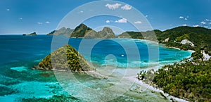 Palawan, Philippines. Las Cabanas beach with rocky mountains and village El Nido in background