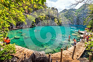 People tourists swimming at Kayangan Lake in Coron Island, Palawan, The Philippines.