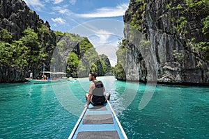 Palawan, Philippines, Young Traveller Sitting on Boat Deck Exploring Big Lagoon in El Nido