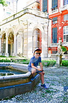 little tourist near Palazzo Rosso ,Genoa , Italy photo