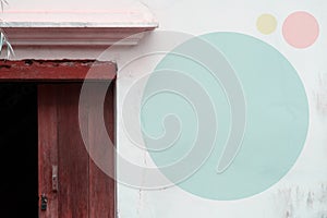 pale blue circle on white concreate wall and wood door