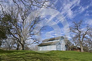 A Pale Blue Dutch Barn, surrounded by Pecan Trees on Property near Richmond, Texas.