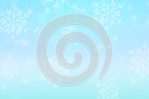 Pale blue winter background with snow and snowflakes and glitter