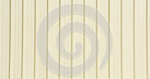 Pale cream metal sheet for industrial building and construction.