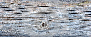 Pale faded brown and cool blue reclaimed pine wood surface with aged boards lined up. Weathered wooden planks on a wall