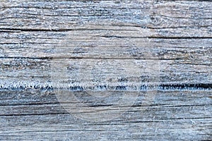 Pale faded brown and cool blue reclaimed pine wood surface with aged boards lined up. Weathered wooden planks on a wall