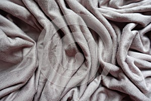Pale grey fabric in soft folds from above