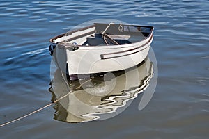 Pale Grey Skiff Reflected in Calm Harbour Waters