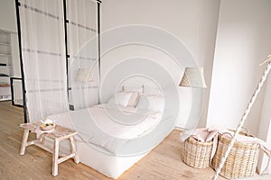 Pale Pink Bedroom in a Minimalistic Style with a Double Bed with Areas for Clothes and for Sleeping