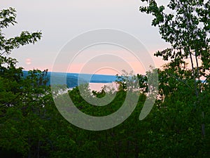 Pale pink Sun sets over Cayuga Lake