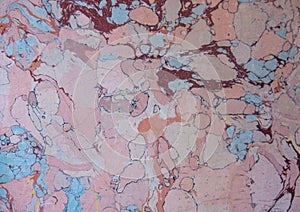 pale smooth pinkish, red and light blue marble texture background in natural patterns close up