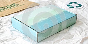 Pale Solid Blue Tone Color Gradation with Light Green Paint on Cardboard Box Recycled Blank Paper Texture Background with Space photo
