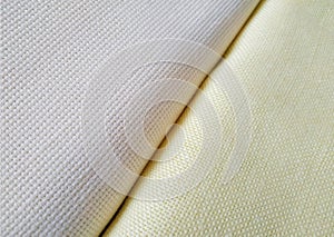 Pale yellow and milk white folded canvas. Fabric texture background