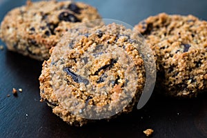 Paleo Chocolate Chip Cookies Made with Coconut and Almond Flour on Dark Wooden Board