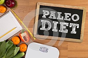 PALEO DIET ( Fitness and weight loss concept, fruit and tape measure on a wooden table, top view)