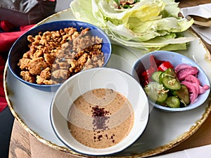 Paleo Diet Food Chicken Pieces with Hoisin Sauce and Cucumber Salad and Wrapped with Lettuce / Chicken Wranch Wraps.