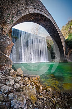 Paleokarya old stone arched bridge between two waterfalls. Trikala prefecture, Greece