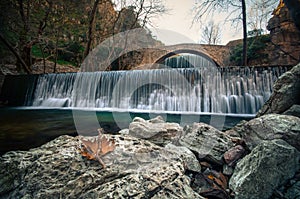 Paleokarya old stone arched bridge between two waterfalls. Trikala prefecture, Greece