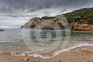 Paleokastritsa bay cliffs and beach on a rainy day