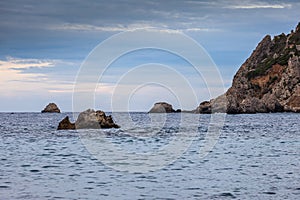 Paleokastritsa bay cliffs and rocks on a cloudy day